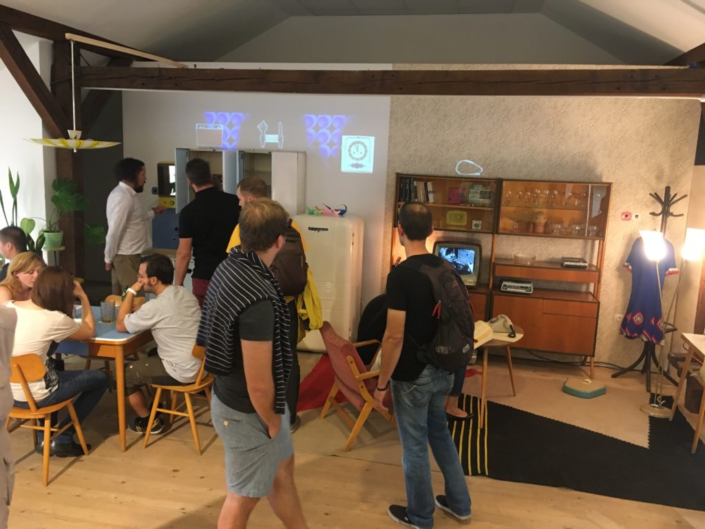 People in the exemplar rooms. The table features the digital alphabet soup and custom software manages the projection and sounds.